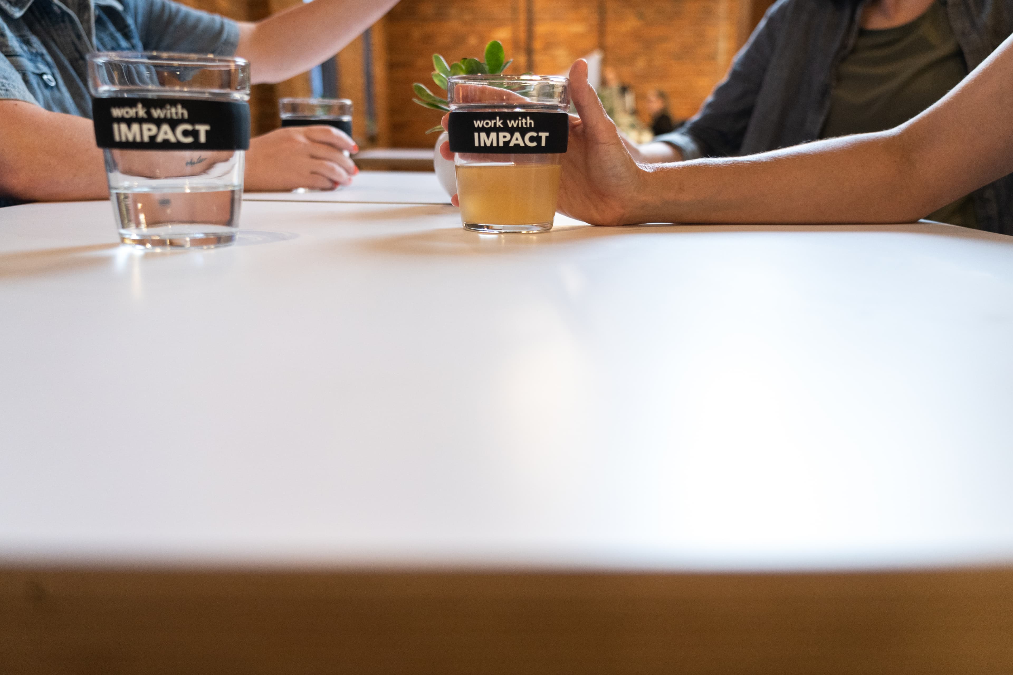 Colleagues conversing while holding their Tonic cups