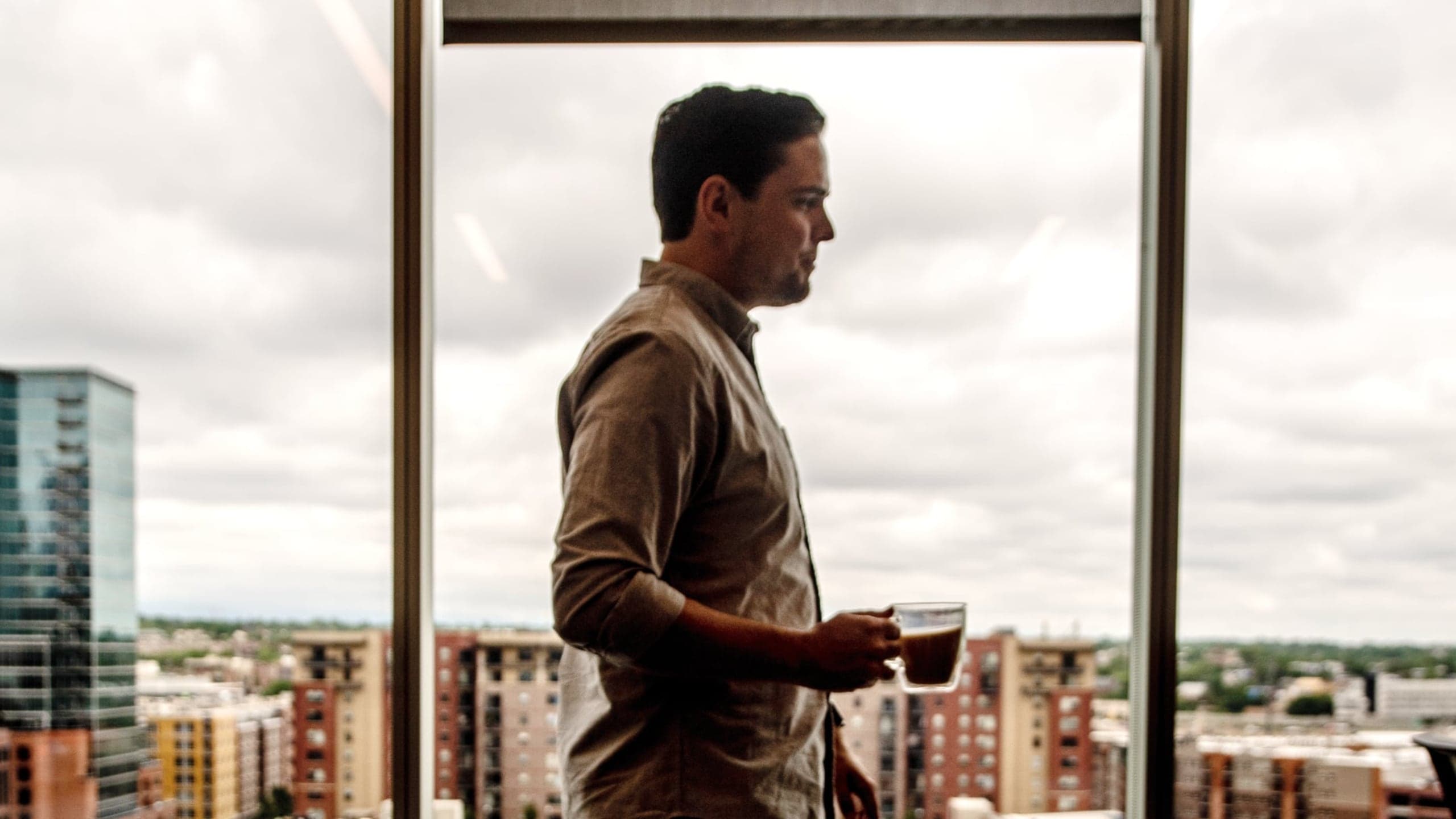 Employee holding a cup of coffee in the office