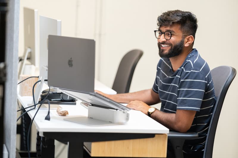 pointing at computer screen