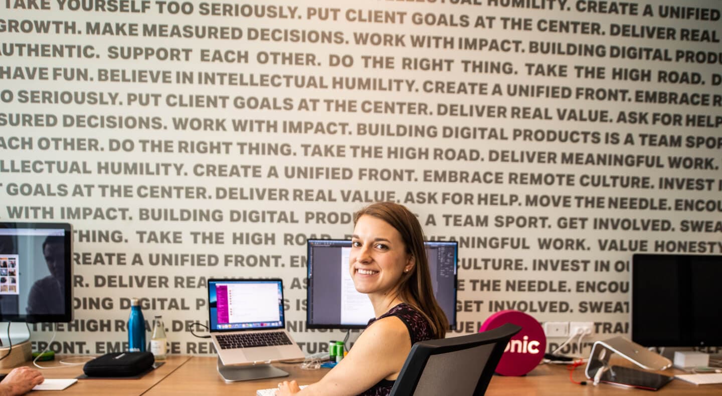 Designer sitting at her desk working on a design project