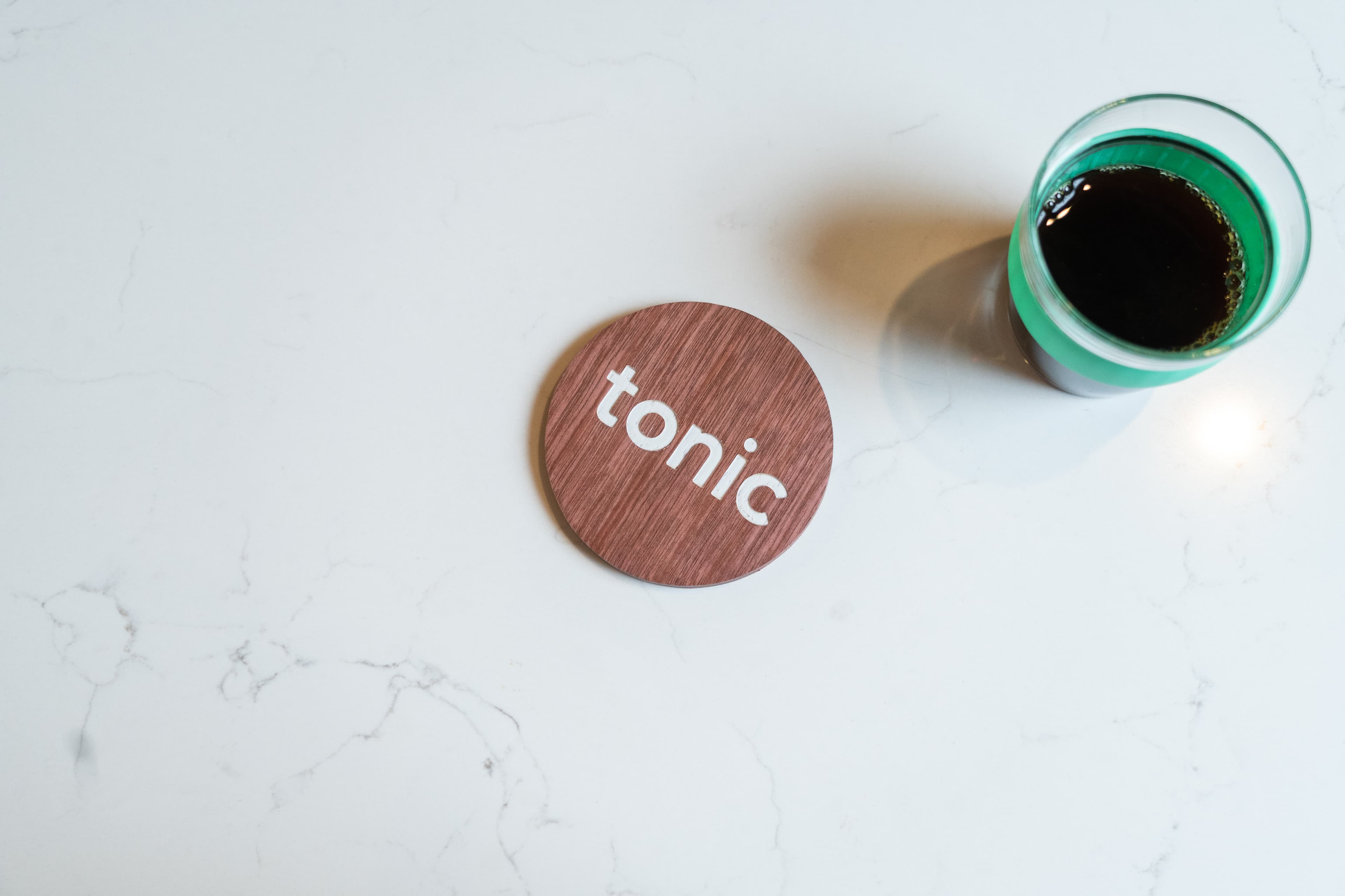 Cup of coffee next to the Tonic logo