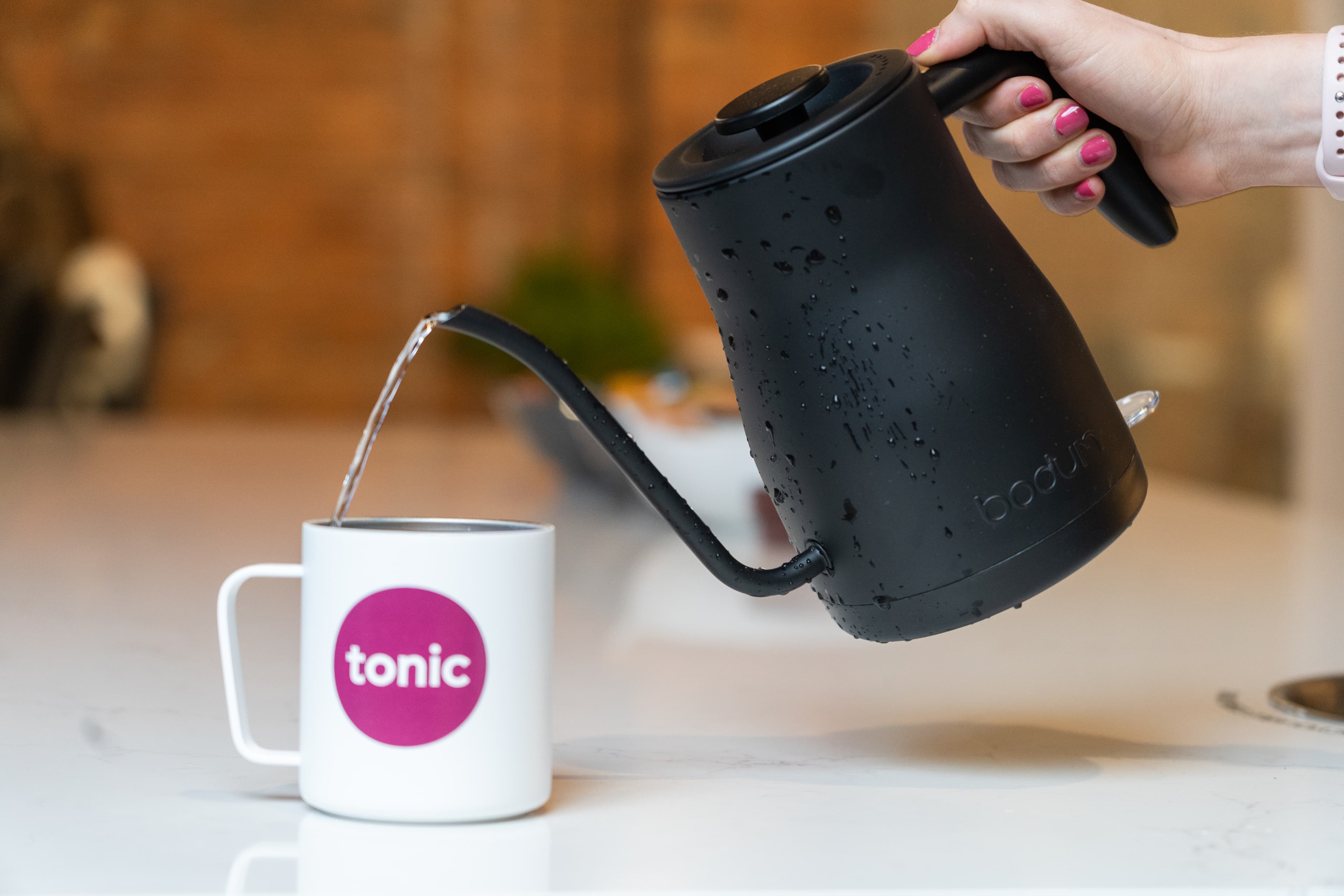 Pouring water into Tonic cup