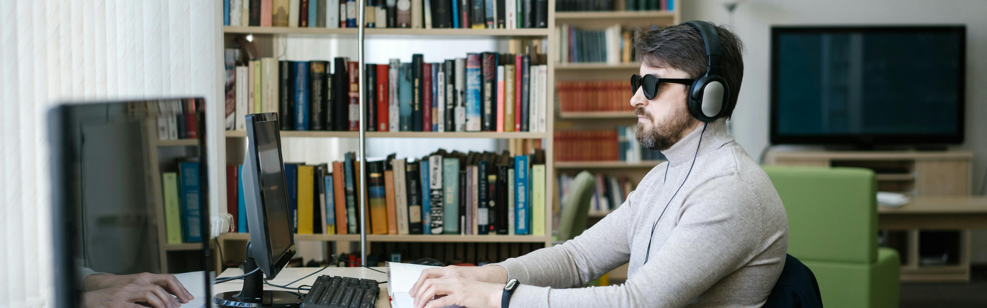 Man reading with headphones on